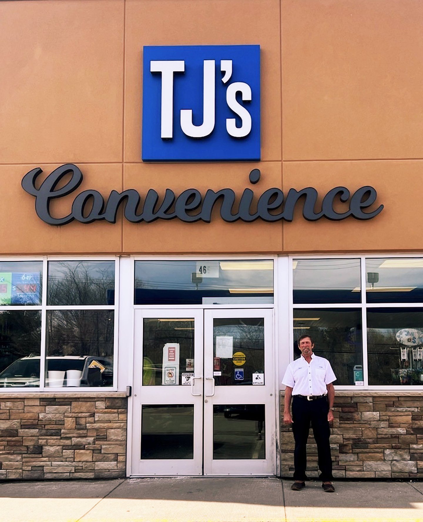 Stephen Morine, owner, stands in front of his store, TJ's Convenience