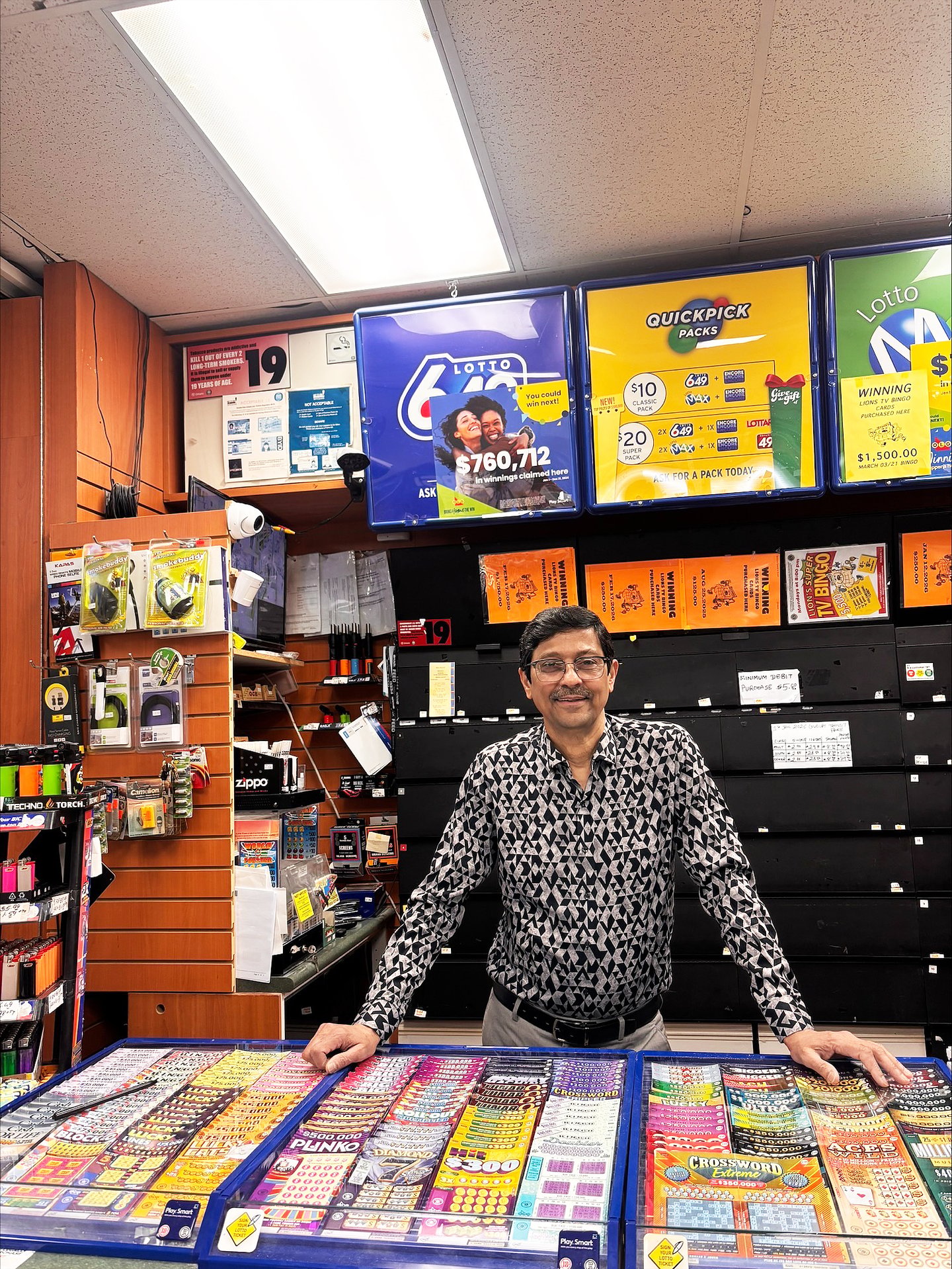 Jay Modi, owner of Willow Smokes and Cigars stands behind the counter