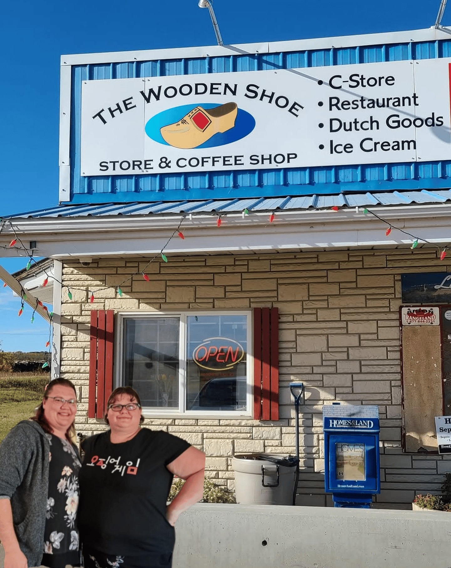 Owners of The Wooden Shoe standing outside their store.