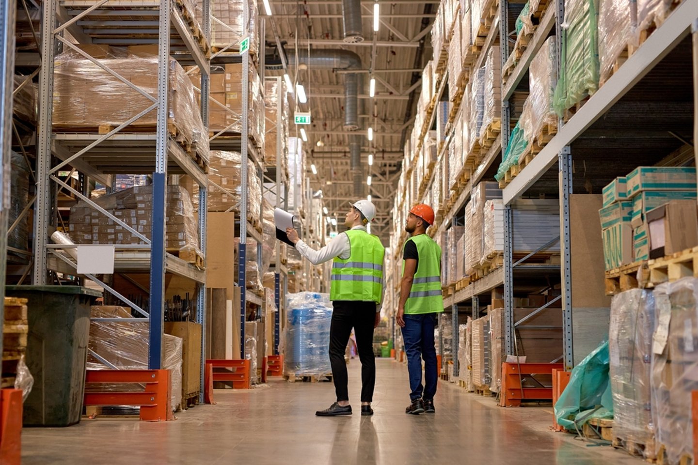 Two men in a warehouse, looking through their inventory