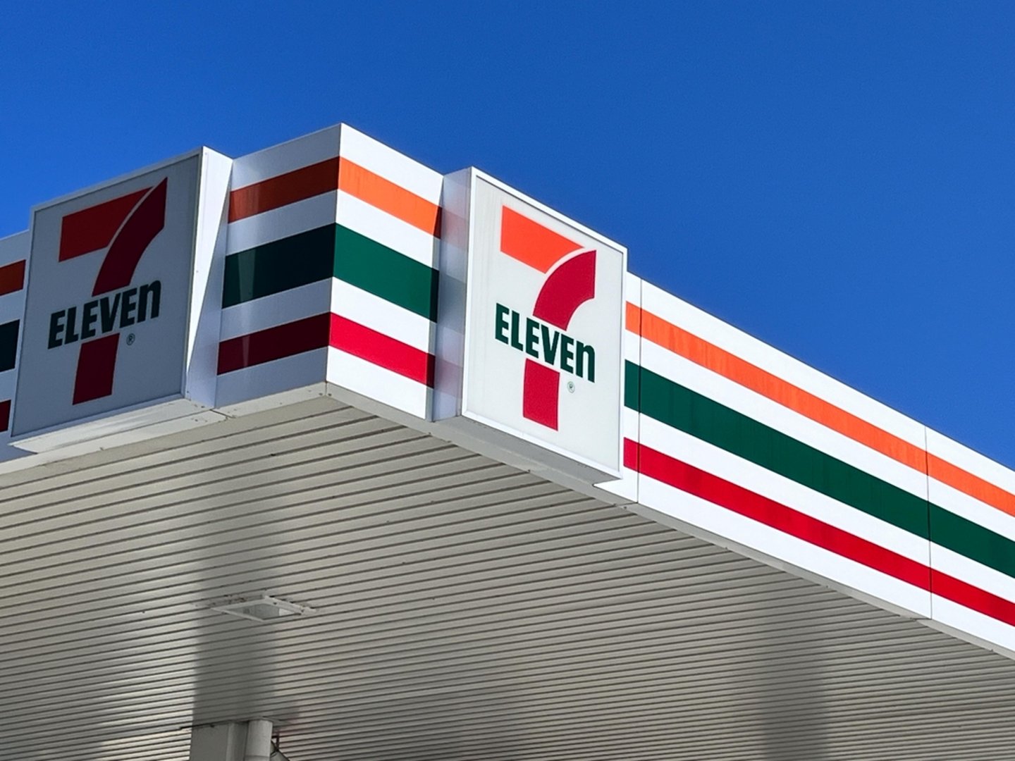 7-Eleven logo above their gas station forecourt