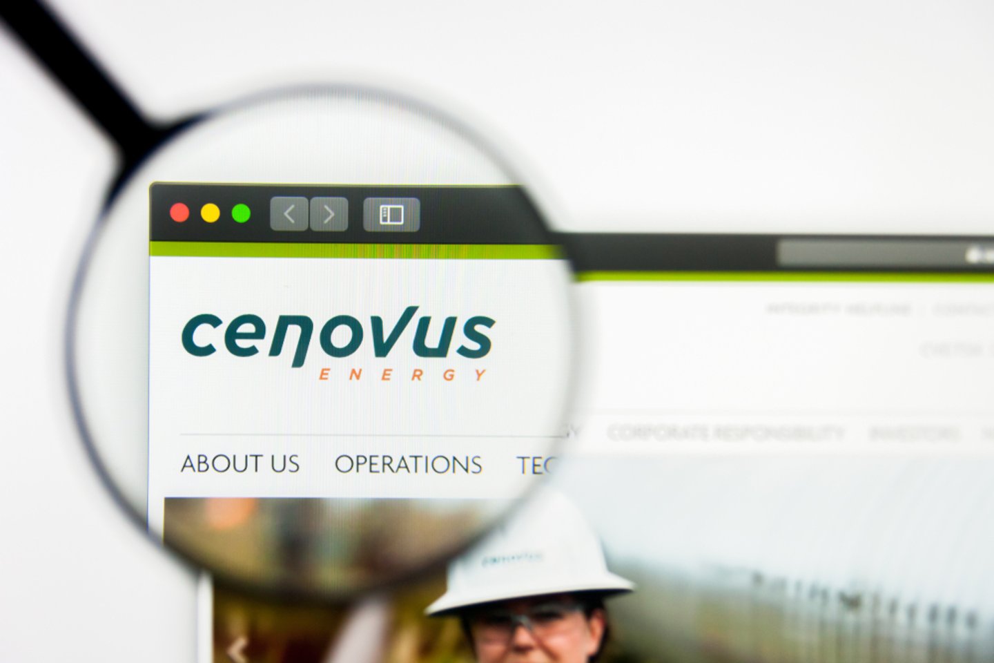 Magnifying glass on the top left corner of a computer screen, highlighting Cenovus logo