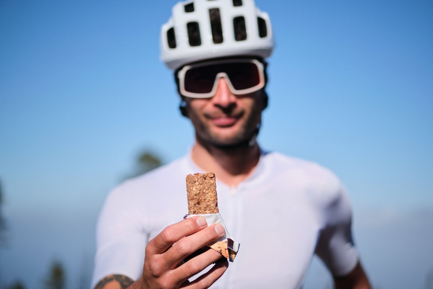cyclist holding up a granola bar