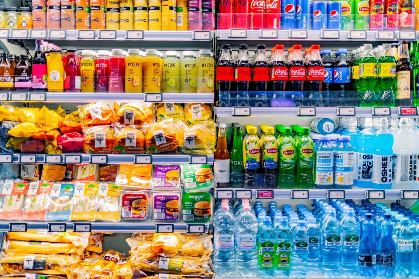 refrigerated shelves with snacks, prepared food and beverages