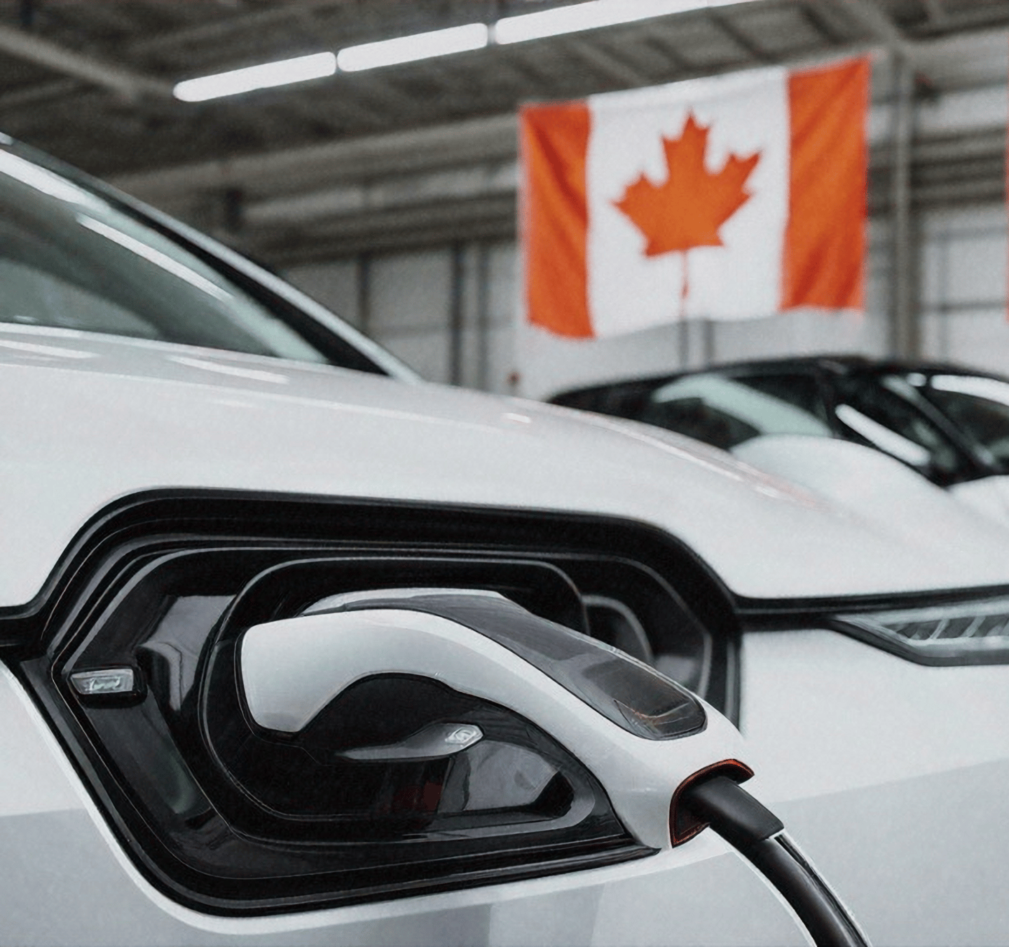 charging EV with Canadian flag in background