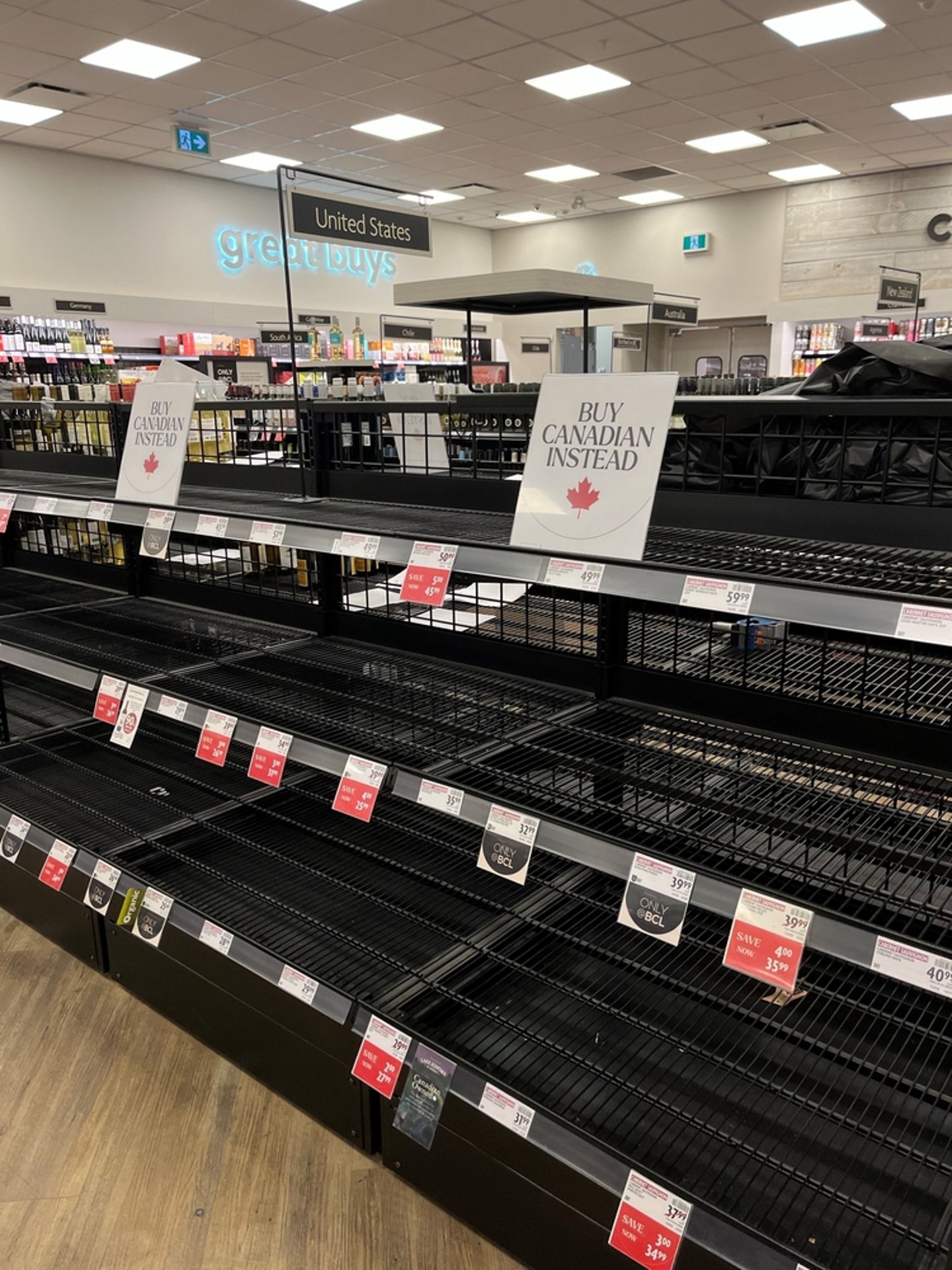 empty shelves in liquor store and buy Canadian sign