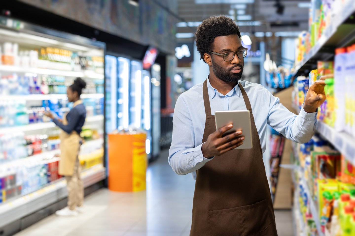clerk and customer in grocery aisle