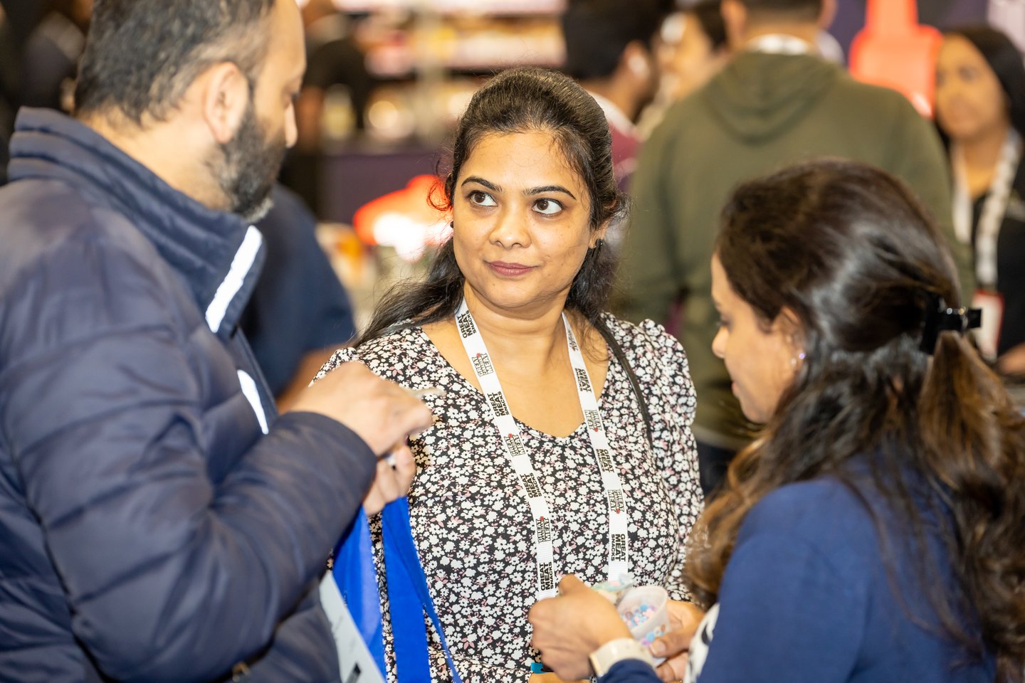 Convenience U 2024 Show Floor attendee speaking with two other persons