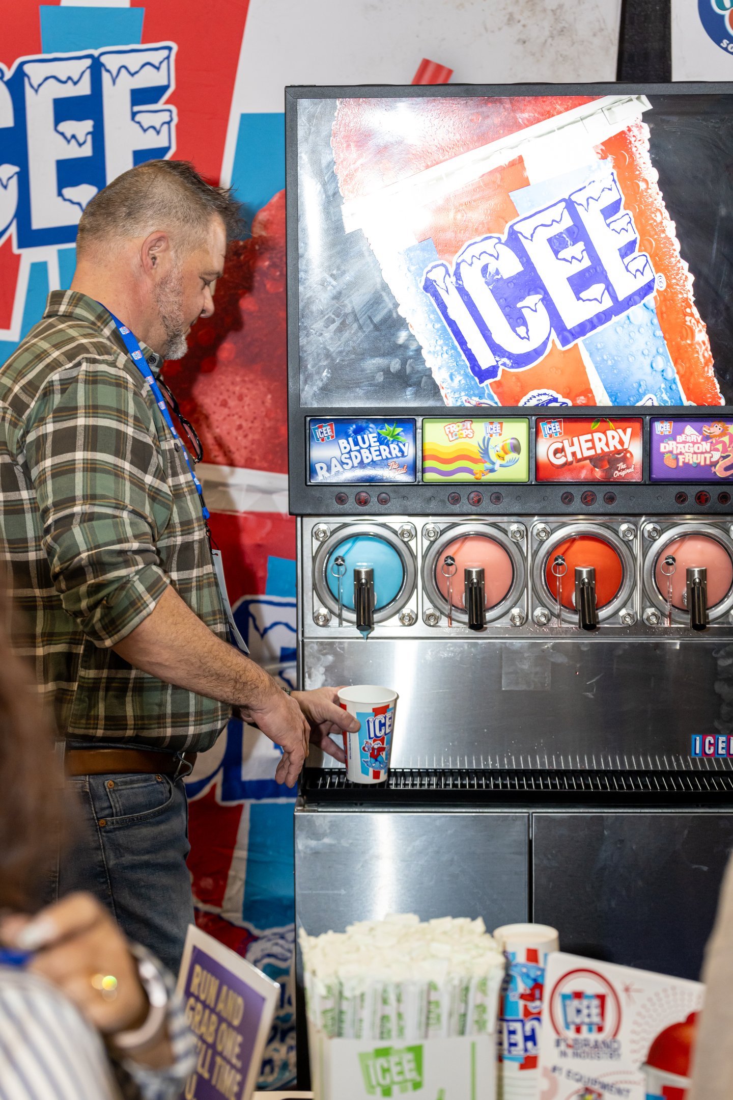 Convenience U 2024 Show Floor Guest in front of Icee Slushie machine