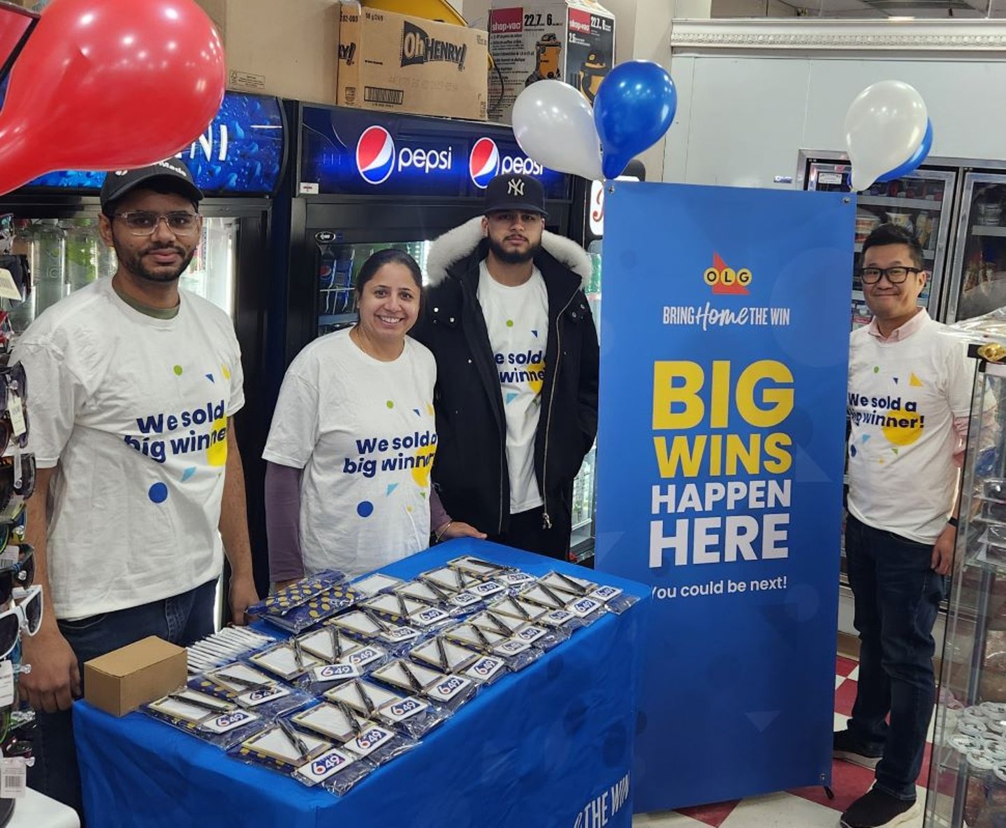 Store staff celebrating lottery winner