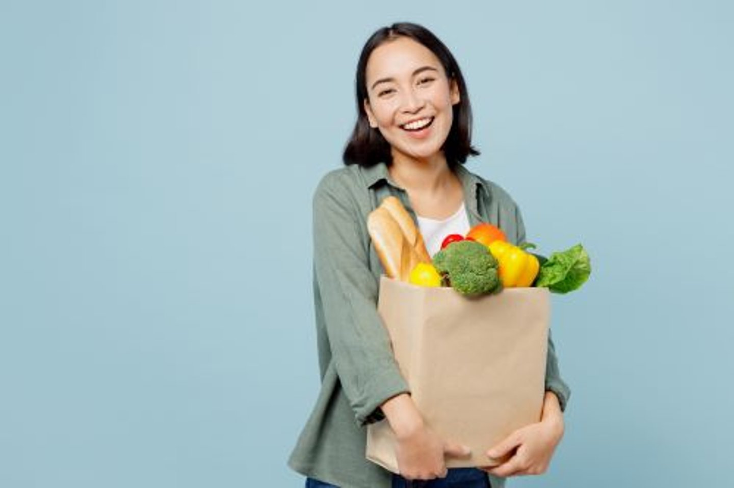 Happy female shopper with grocery bag