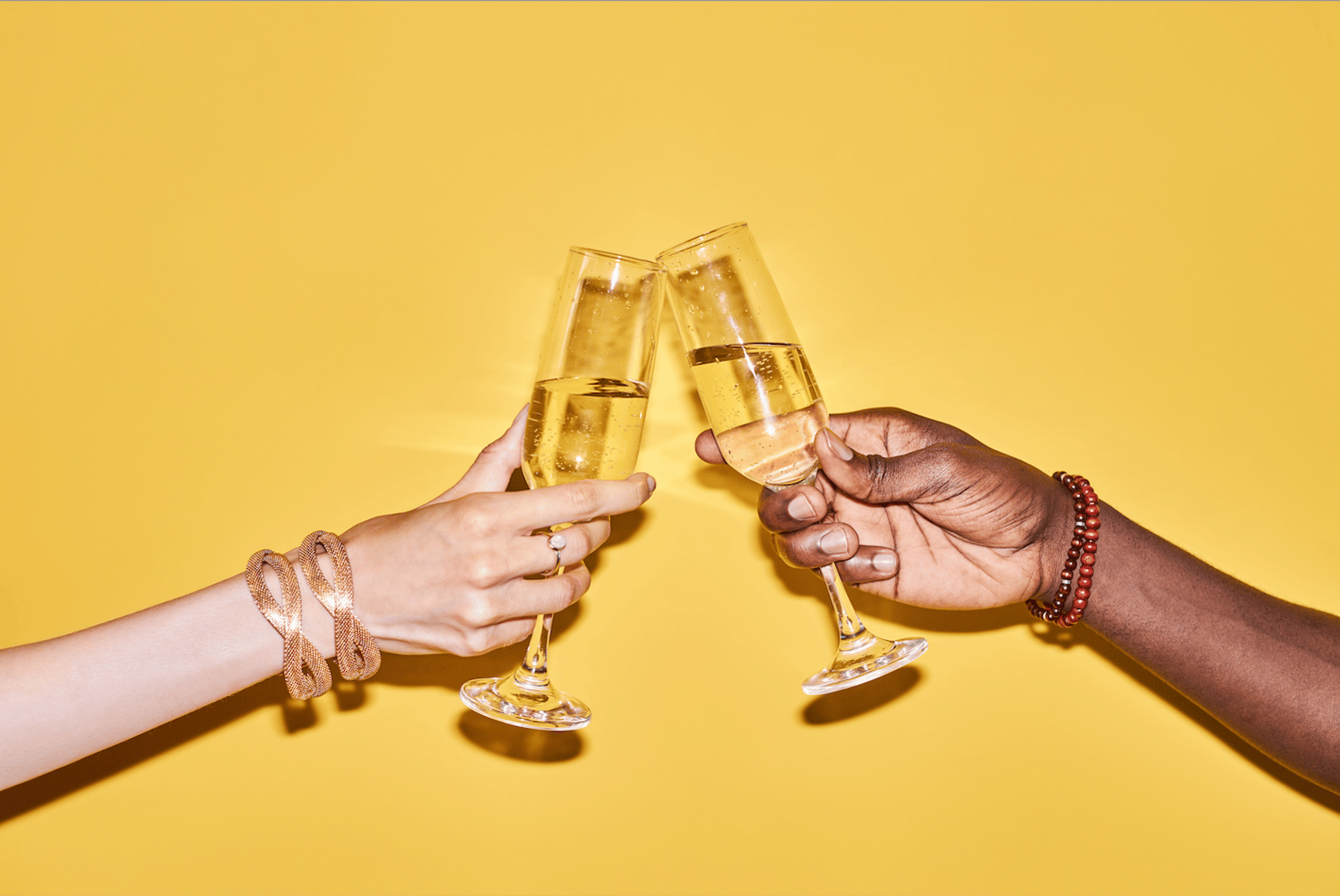Cheers, sparkling wine, two hands in toast