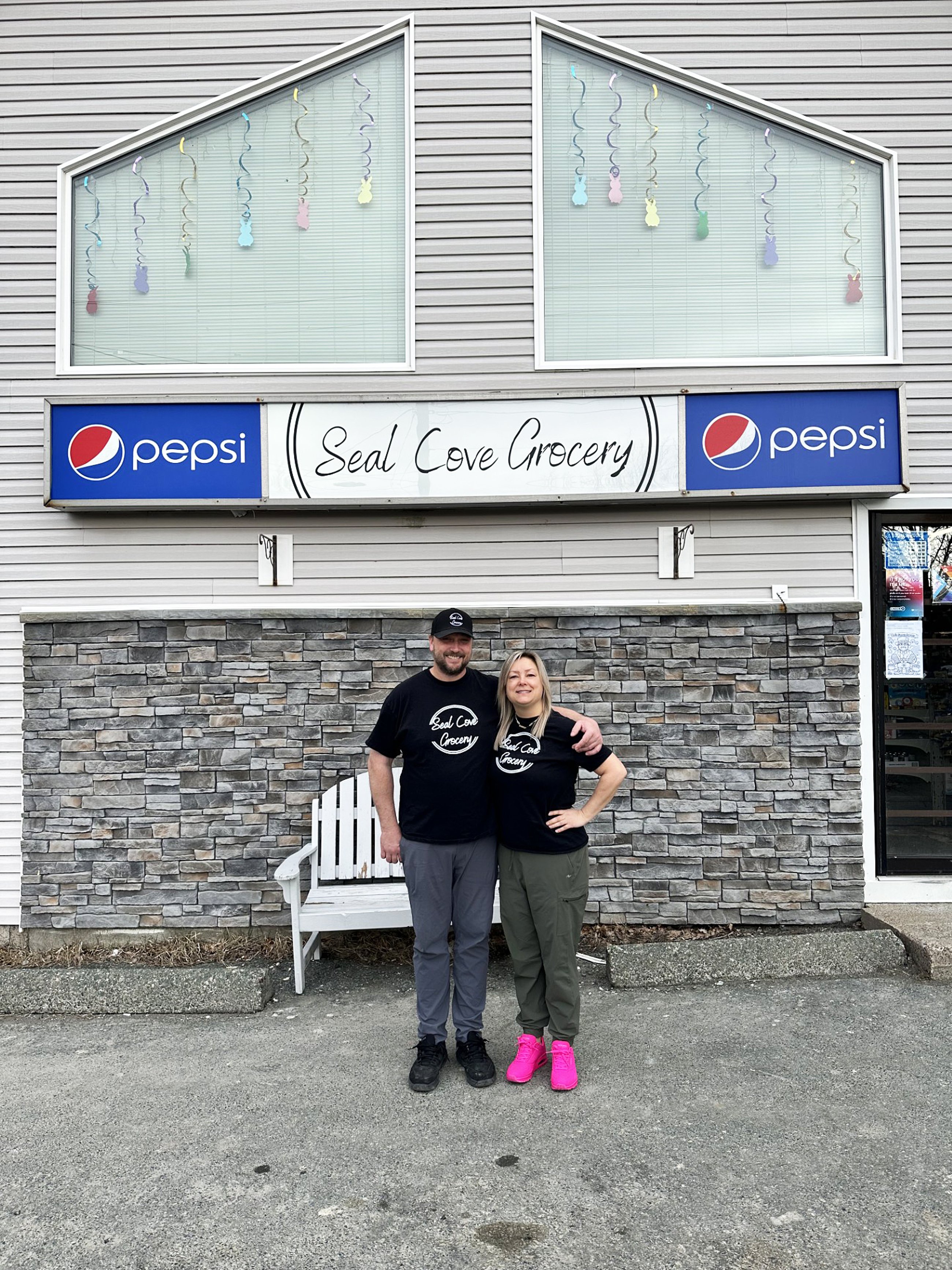 Owners of Seal Cove Grocery & Liquor Express, Kristen and Thomas Dwyer stand in front of their store