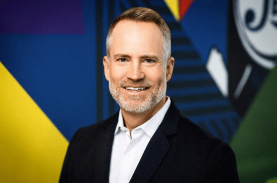 Patrick Charbonneau headshot on a blue and yellow background