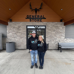 Owners of Sweetleaf standing outside, in front of their store.