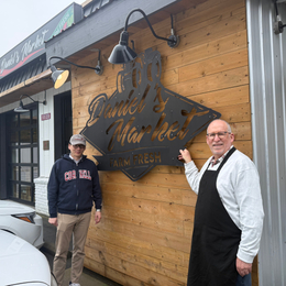 Daniel Tsai and manager outside Daniel's market