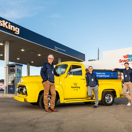 Brent Morris, left, in front of a bright yellow truck in Gas King's forecourt