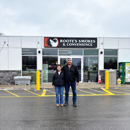 Owners: Brenda and Randy Roote in front of their gas pumps at Roote's Gas Barote"s