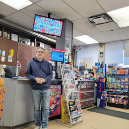 Sean Lee stands in front of the counter in his store, Seafair Smoke & Mixers