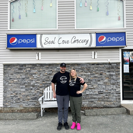 Owners of Seal Cove Grocery & Liquor Express, Kristen and Thomas Dwyer stand in front of their store