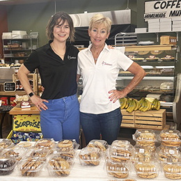 Kayla Helliker (left) and Sherry Mowat (right) owners of Sherry's convenience store standing inf fornt of a selection of baked goods. 