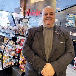 Operator Éric Labranche in front of his counter at Dépanneur Voisin Famille Baril