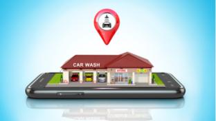 The building of the car wash and store is located on the smartphone. 3D illustration