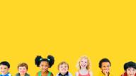 children smiling against a yellow background