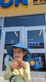 child enjoying a cookie in front of On the Run