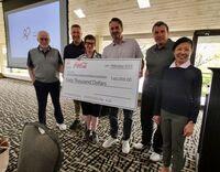 Coke team with big cheque