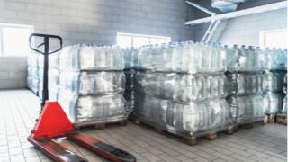 water on palettes in a warehouse