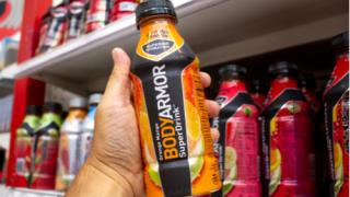 A hand hold a bottle of Body Armor, or BodyArmor at a grocery store T