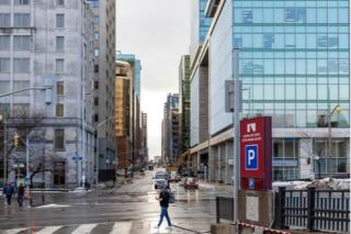 Ottawa, Canada - December 16, 2021: Cityscape view with skyscrapers in downtown of Ottawa, Elgin Street and Slater St. People crossing road