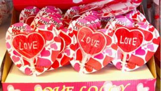 Red love lollies in cellophane, candy and sugar sweets for Valentine and Mothers Day celebrations