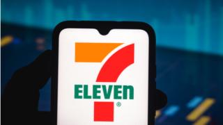 In this photo illustration the 7-Eleven logo seen displayed on a smartphone screen
