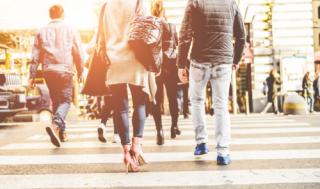 Crowd of people walking on zebra crossing street city center - Concept of modern, rushing, urban, city life, business, shopping - Focus on woman black bag