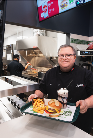 Triple O manager serving food at Parkland