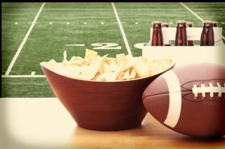 Super Bowl football with a bowl of chips and beer