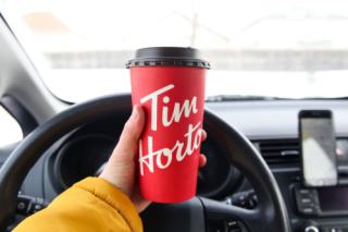 Winnipeg, Manitoba / Canada - February 17, 2020: Holding a Tim Hortons Large Cup of Coffee.