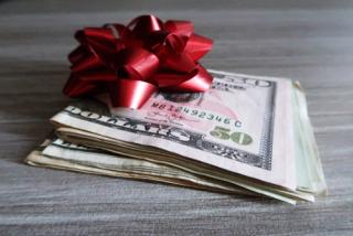stack of american cash with a bow on it