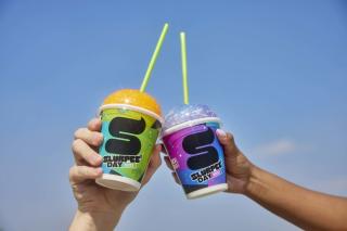 Two hands cheersing Slurpees
