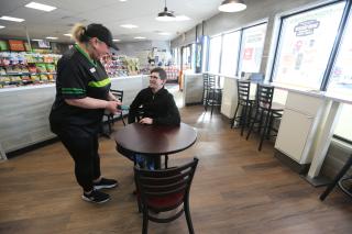 7-Eleven interior with server and patron