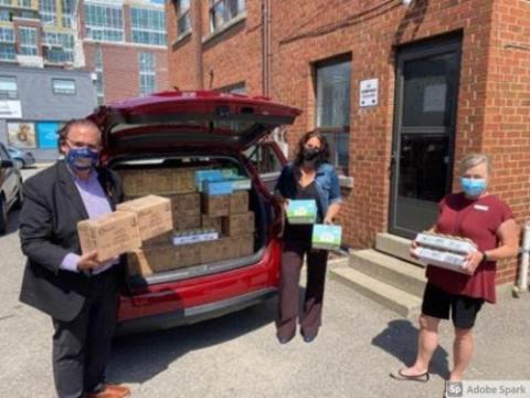 Photos of Rabba and others loading donations into vehicle