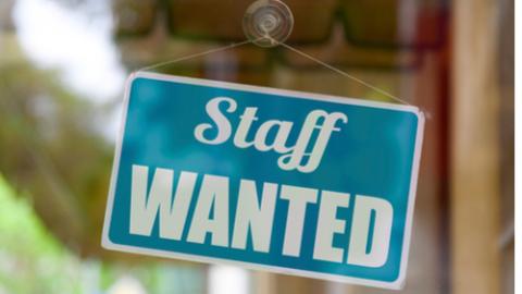 Staff wanted sign signifying labour shortages