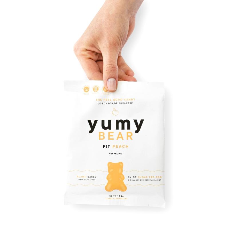 hand holding peach Yumy Bear