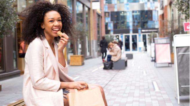 woman eating a protein bar