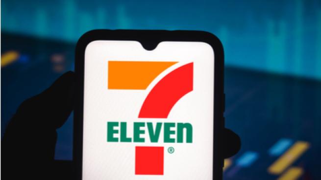 In this photo illustration the 7-Eleven logo seen displayed on a smartphone screen
