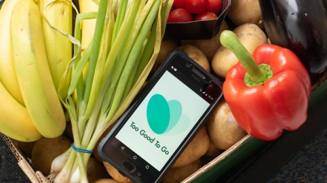Tilburg, Netherlands - 05.18.221: Box of almost expired food - vegetables and fruits saved from waste with Too Good To Go app. Zero waste grocery shopping via app fighting with throwing out food.