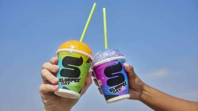 Two hands cheersing Slurpees