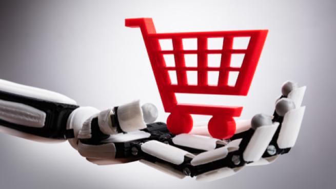 Close-up Of A Robotic Hand Holding Red Shopping Cart On Gray Background